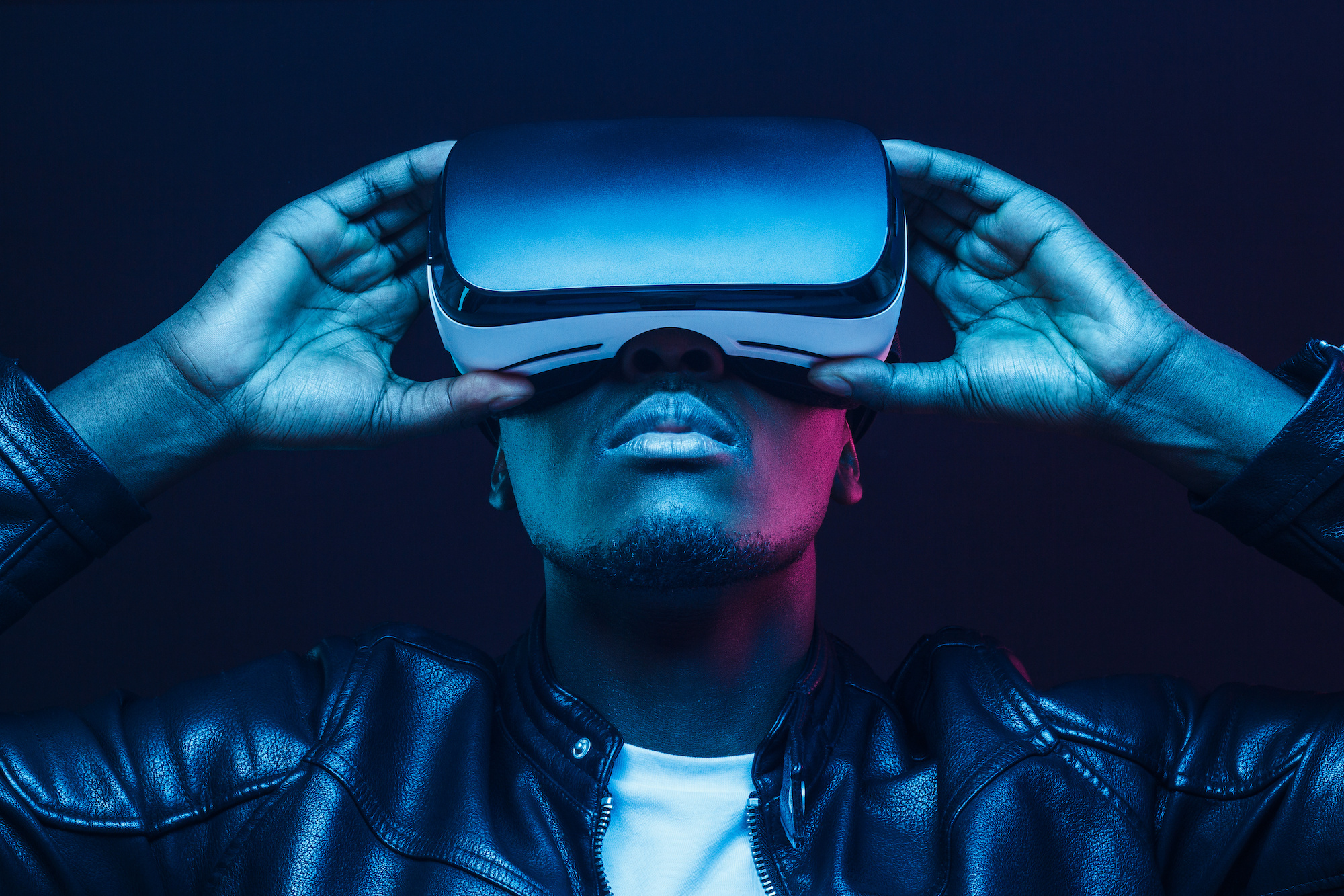 Portrait of African guy isolated on black background wearing headset of virtual reality Portrait of African guy isolated on black background wearing headset of virtual reality