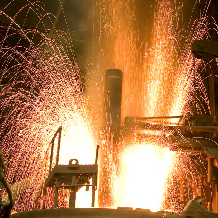 Custom photoshoot of forge in action with sparks flying