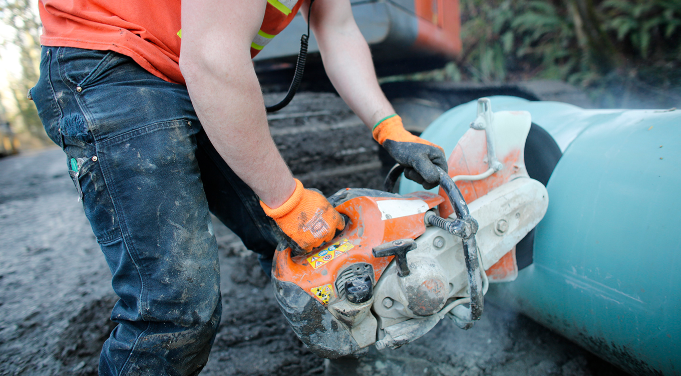 Image of custom photoshoot of man with saw on pipe