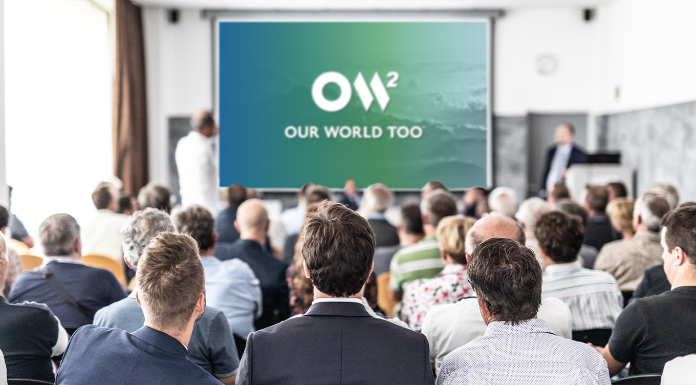 Photo of OW2 PowerPoint template on projection screen during a presentation